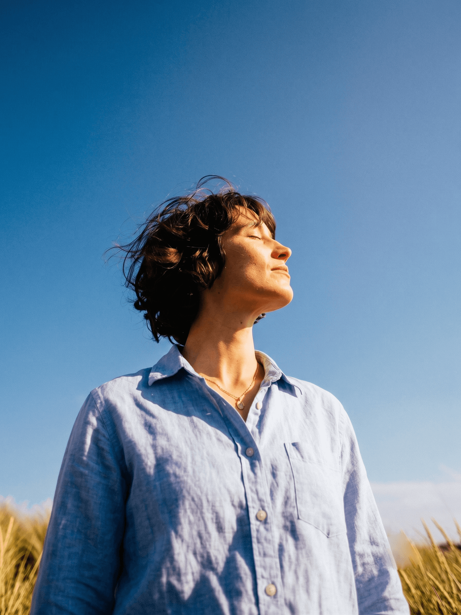 Portrait in blue beneath a clear sky