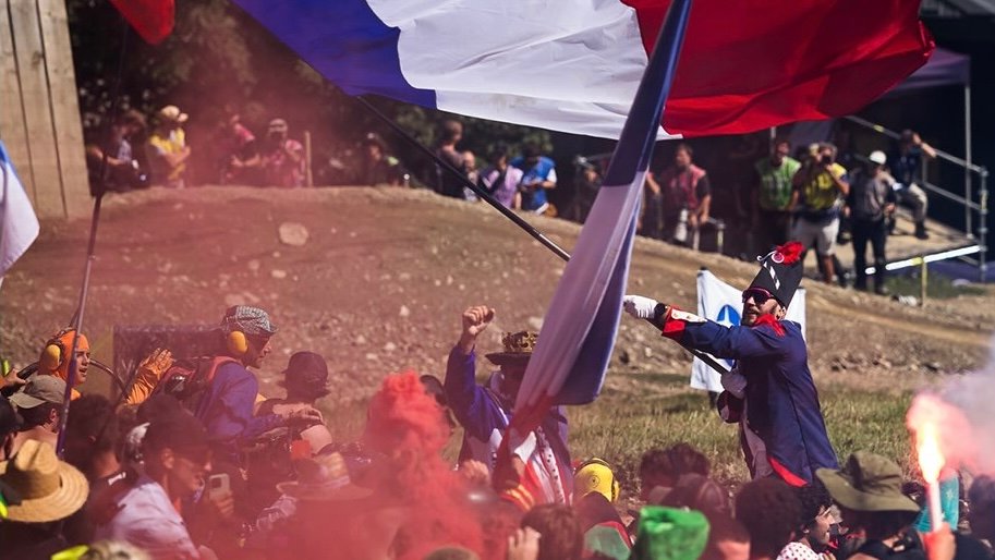 French flag waving above a crowd at an event